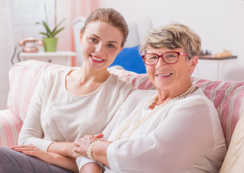 Elderly woman with woman caregiver